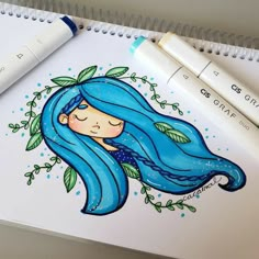 a drawing of a girl with blue hair and green leaves on her head is next to two markers