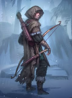 a man with a bow and arrow standing in the snow