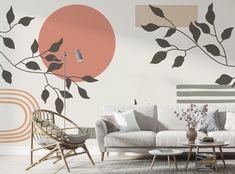 the living room is decorated with modern wallpapers and art deco touches, such as this tree branch mural