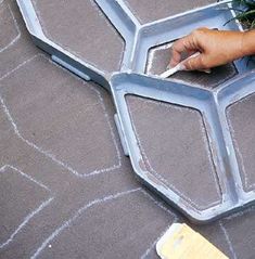 someone is painting the top of a piece of furniture with white paint and some green plants