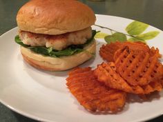 a chicken sandwich and waffle fries on a plate