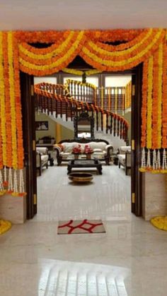 an entrance decorated with orange and yellow flowers for a wedding ceremony or reception at the same time