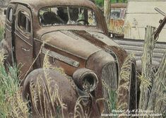 an old rusted car sitting in the middle of tall grass next to a fence