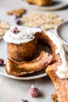 a plate topped with doughnuts covered in icing and cranberry topping