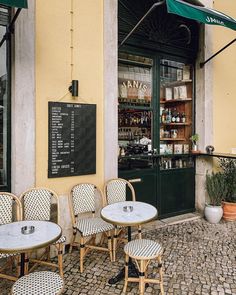 an outdoor cafe with tables and chairs outside