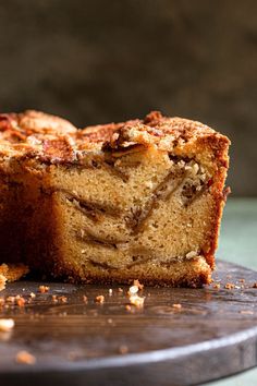 a sliced cake sitting on top of a wooden cutting board