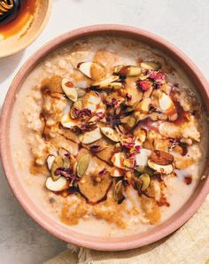 a bowl filled with oatmeal and nuts on top of a table