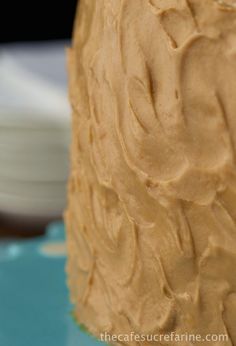 a frosted cake sitting on top of a blue plate