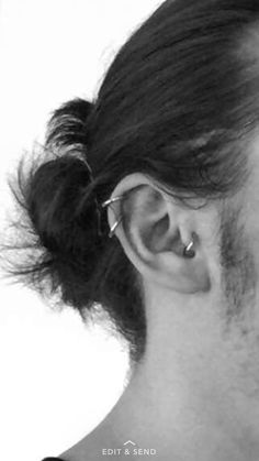 a man with long hair and piercings on his ear