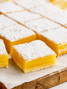 several pieces of lemon bars on a cutting board