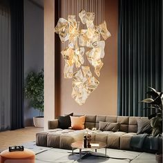 a living room filled with furniture and a chandelier hanging from the ceiling above it