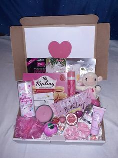 a pink gift box filled with personal care items