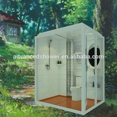 an open white box with a toilet and shower in the middle of a wooded area