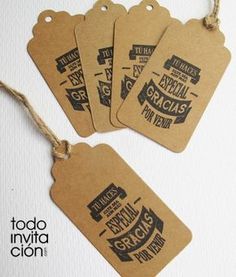 four brown tags with black and white typograms are hanging from twine