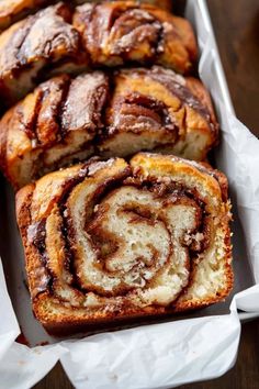 several cinnamon rolls in a white box on a table