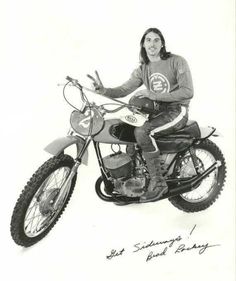 a woman sitting on top of a dirt bike