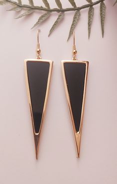 the black and gold triangle earrings are on display