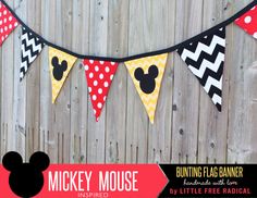 mickey mouse banner hanging on a fence