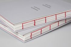 two books are stacked on top of each other with red lines running down the pages