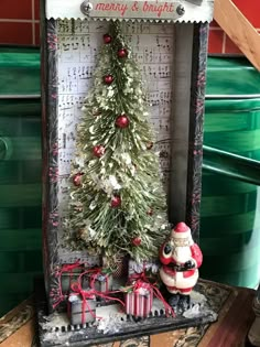 a small christmas tree sitting inside of a box