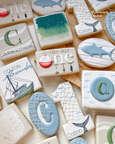 some cookies that are on top of a wooden table with letters and animals painted on them