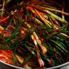 green beans and red sauce in a pan