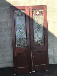 two wooden doors with stained glass on them