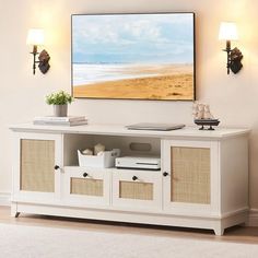 a white entertainment center with wicker baskets on the doors and drawers in front of it