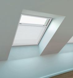 an empty room with two skylights on the ceiling