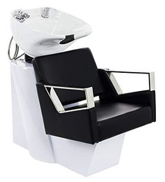 a black and white chair sitting next to a sink