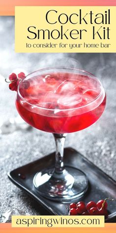 a cocktail sitting on top of a tray with cherries in the background and text that reads cocktail smoker kit to consider for your home bar