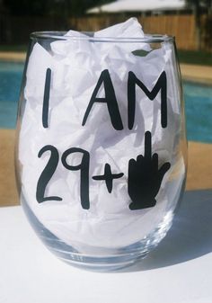 a wine glass with the words i am 29 plus written in black ink on it