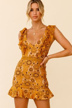 Mustard dress  Floral lace overlay fabric  Lined  V-Neckline  Adjustable ruffle straps  Ruffle hem  Criss-cross back  Invisible zipper in back   Make an entrance in our pretty Short Story dress. It's giving us all the girly vibes with that lace overlay and ruffle straps. Wear it to lunch dates with your besties or to work for ultimate style-queen status. Team it with strappy block heels for an on-trend look. Girly Vibes, Strappy Block Heels, Mustard Dressing, Pretty Shorts, Clothing Tags, Short Story, Back Dress, Dress Floral, Lace Overlay