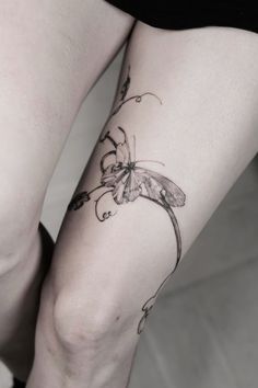 a woman's leg with a butterfly tattoo on it