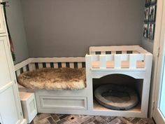 a dog bed in the corner of a room with gray walls and white trimmings