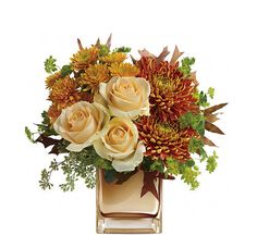 an arrangement of flowers in a vase on a white background