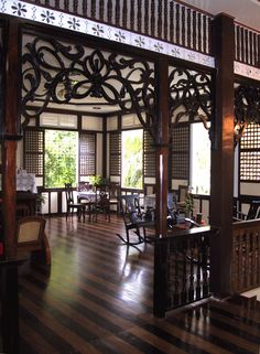 the inside of a restaurant with wooden tables and chairs, wood flooring and large windows