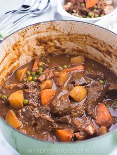 beef stew in a pot with peas and carrots on the side, ready to be eaten