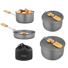 four pots and pans with wooden utensils in them, set on a white background