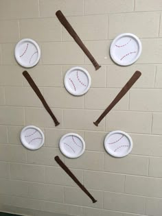 paper plates with baseballs and sticks on them are arranged in the shape of a circle