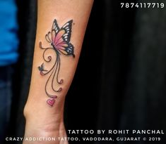 a woman's arm with a butterfly tattoo on it