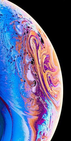 the back side of an iphone with blue and purple swirls on it, against a black background