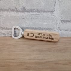 a bottle opener with an engraved message on the front that says,'battery table boston divine here '