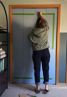 a woman standing in front of a book shelf