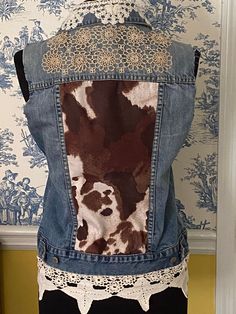 the back of a jean jacket with lace on it