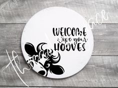 a sign that reads welcome to we are your hooves on it, with a cow's head in the center