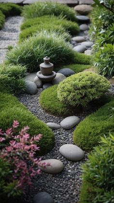 a garden with rocks, grass and flowers