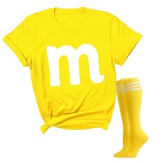 a yellow t - shirt with the letter m on it next to a pair of socks