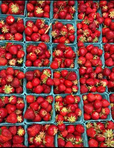 several baskets filled with strawberries sitting next to each other