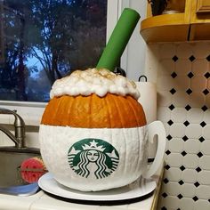 a starbucks pumpkin sitting on top of a kitchen counter